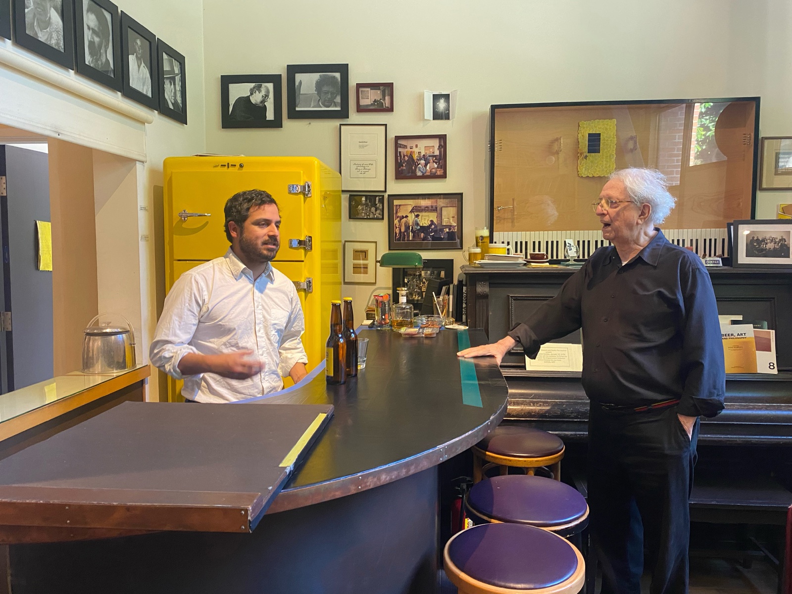 Alberto Cuadros and Tom Marioni in conversation at the bar of the Society of Independent Artists, Marioni's San Francisco studio.